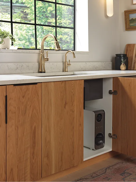 Kitchen sink with champagne bronze Delta faucets and Clarify Tankless Water Filtration System in cabinet underneath.