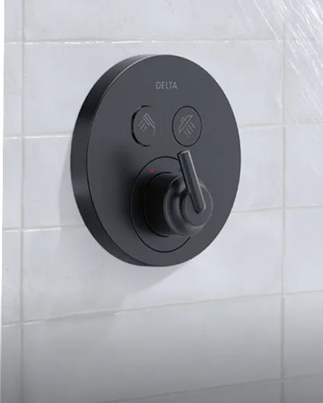 Delta Select Choice push button shower trim in matte black shown on off-white tiled shower wall with shower water flowing above it.