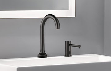 Black modern faucet with soap dispenser in bathroom