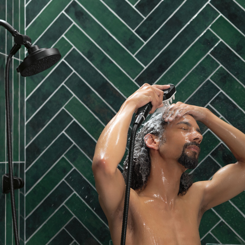 man using Versacurl to rinse his hair
