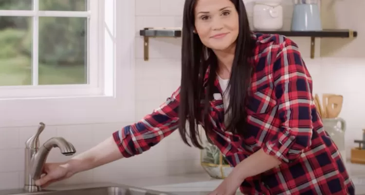 Hannah of Mike and Hannah preparing to install new kitchen faucet
