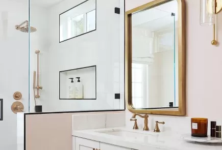 bright white bathroom with champagne bronze faucet and shower fixtures