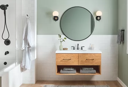 light bathroom with two in one shower and circle mirror