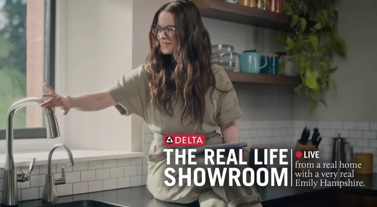 Emily Hampshire touching a kitchen faucet
