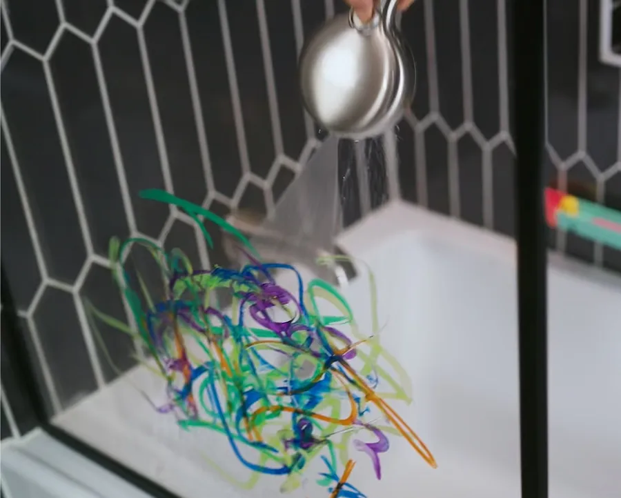 Delta SpotShield Brushed Nickel  shower head ProClean sprays bathtub shower stall glass to remove colored marker lines.