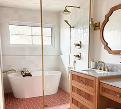 Bright bathroom vanity featuring a Delta single‑handle faucet, white countertop, and decorative accessories arranged neatly.